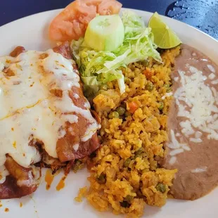 Chicken Enchiladas with red sauce. Good flavor. Did not like rice or beans.