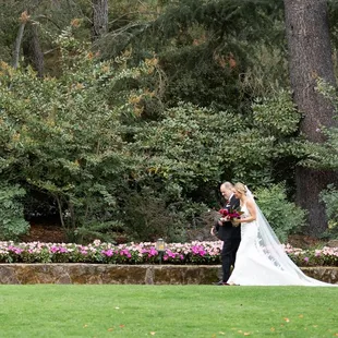 Bride and Groom going for a stroll along the grass.