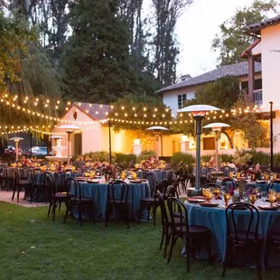 As the sun sets the lights illuminate the outdoor reception space.