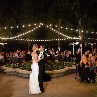 The Bride and Groom enjoying their first dance under the warm bistro lights.
