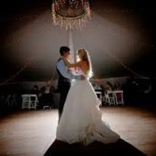 Beautiful couple having their first dance in the tent.