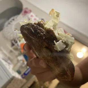 a hand holding a piece of food