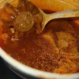 a bowl of stew with a spoon