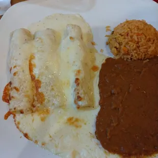 Chicken enchiladas with sour cream sauce, beans &amp; rice