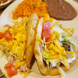 Puff taco plate. #31 one chicken and one beef with rice and beans.