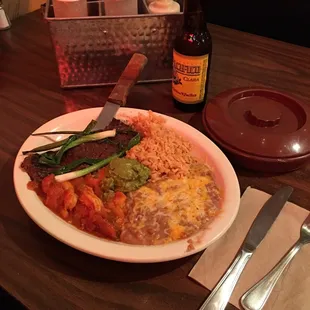 The "Tierra Y Mar." Thin Carne Asada steak, shrimps, rice and beans with some fantastic green onions!...