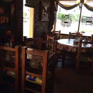 a dining area with tables and chairs