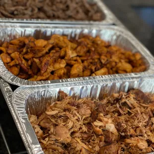 three pans of pulled pork