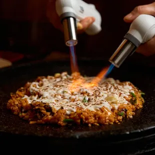 a person cooking a pizza