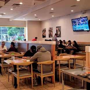 people sitting at tables in a restaurant