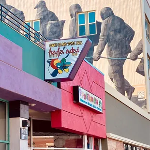 Outside sign.  You'll need to go through the alley underneath the sign to get to the restaurant