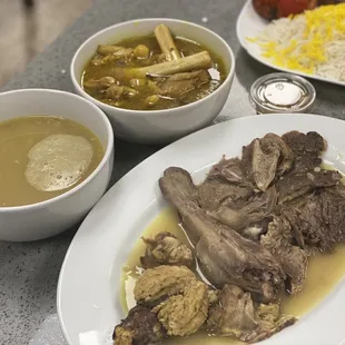 a plate of meat, rice, and soup