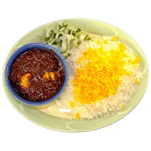 Fesenjan Stew: Chopped walnuts stirred into chicken and pome- granate molasses, with a sweet and sour flavor, served with basmati rice