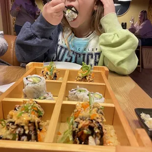 a young girl eating ramen