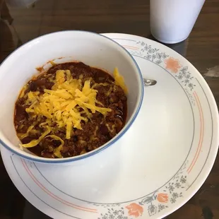 a bowl of chili and cheese