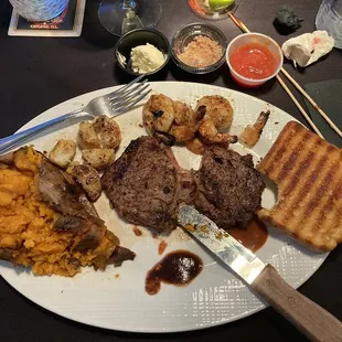 Steak, shrimp and scallops with Texas toast and a sweet potato