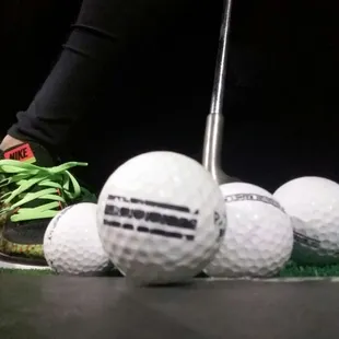 a person putting golf balls on a tee