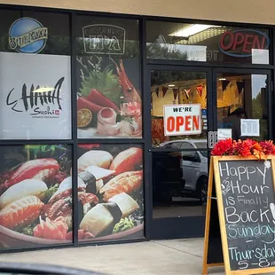 a sign in front of a restaurant