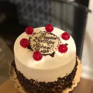 a birthday cake with cherries on top