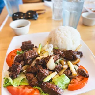 a plate of beef and vegetables