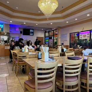 people sitting at tables in a restaurant