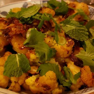 Balinese cauliflower ($14.50), vegan by default. Fine. Oily. Weird coconut sauce below it all.