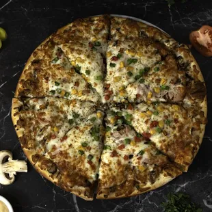 GODZILLA:  cheese, shredded beef mortadella, chicken &amp; beef Jambon, with extra Mortadella slices, mushrooms, beef hot dog, corn, tomatoes