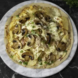 Loaded Chips: Potato chips topped with shredded beef mortadella, chicken &amp; beef Jambon, mushrooms, green peppers, and oregano seasoning