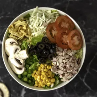 Salad with chopped lettuce, tomatoes, corn, mushroom, shredded beef mortadella, chicken &amp; beef Jambon, chips, Cheese and Haida Sauce