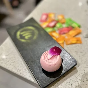 a pink dessert with a flower on top