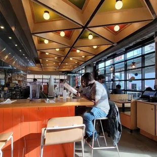 a man sitting at a counter in a restaurant