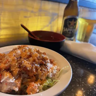 a plate of food and a bottle of beer