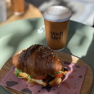Croissant with Egg, avocado, bacon, cheese, tomato and salad. Delicious!!