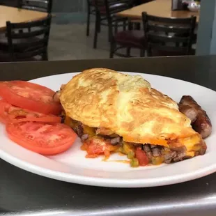 Omelette with sausage, cheddar cheese, tomatoes, green peppers.