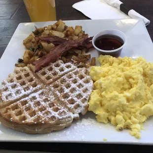 Waffles with eggs , home fries and bacon