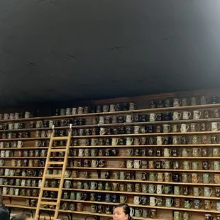a wall of beer mugs