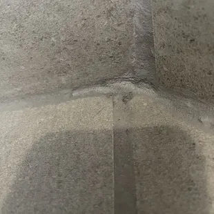 Messy grout and tile in our master shower. Seams don&apos;t match either.