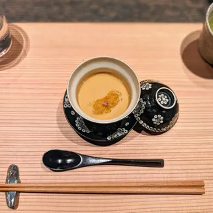 a cup of tea and chopsticks on a table
