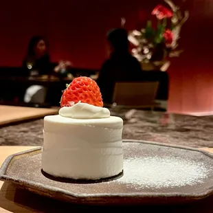 a white cake with a strawberry on top