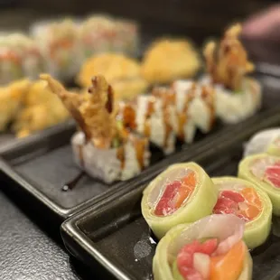 a variety of sushi rolls on a tray