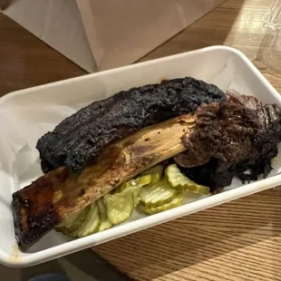 a plate of ribs and vegetables