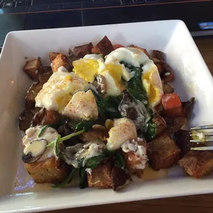 Spinach and shiitake Benedict over home fries. Gluten free indulgence.