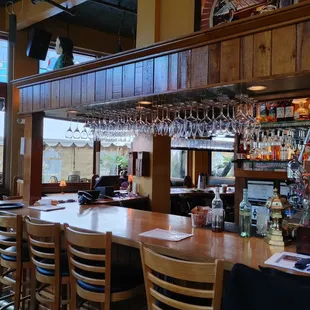 a bar with a long wooden table and chairs
