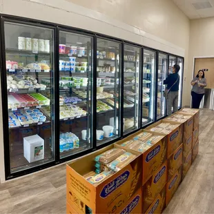 a woman standing in front of a refrigerated refrigerator