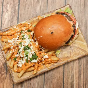 a burger and fries on a cutting board