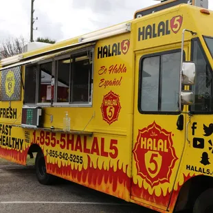 a yellow food truck parked in a parking lot