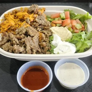 My spicy chicken/gyro, rice, salad, tzatziki, hummus with red &amp; white sauce