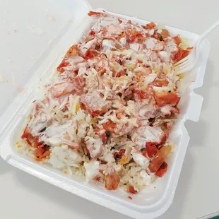 Chicken over rice with extra white sauce.