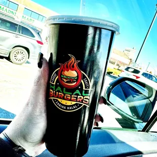a hand holding a coffee cup