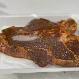 a piece of steak in a styrofoam container